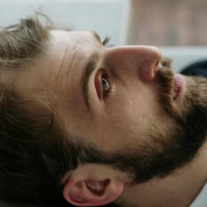 Portrait of a thoughtful bearded man indoors, reflecting on emotions and mental health.